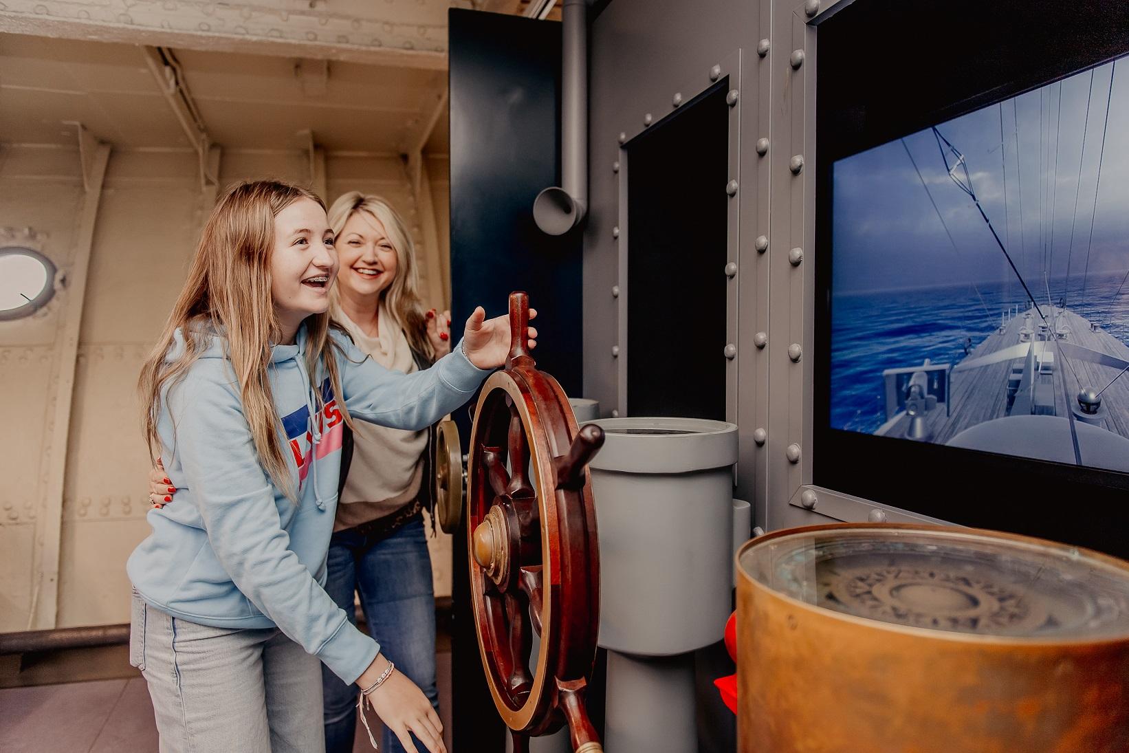 Mother and daughter enjoy the Virtual Access Suite onboard HMS Caroline