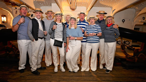 Group on board HMS Warrior dressed as sailors