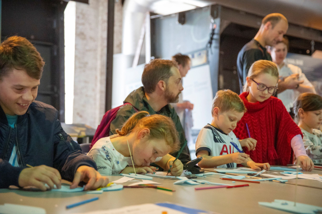 Group of children sitting at a table and drawing