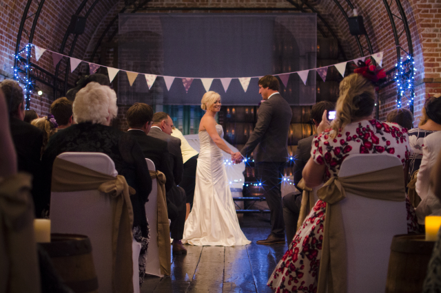 Bride and groom at the alter in Grand Magazine