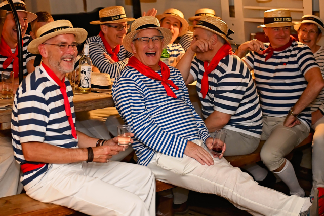 Group of people on table singing