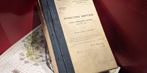 One of the original Operation Neptune naval orders in a case at the National Museum of the Royal Navy