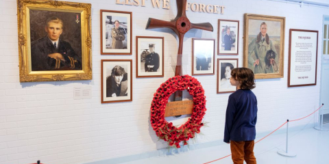 Child standing in front of memorial wall